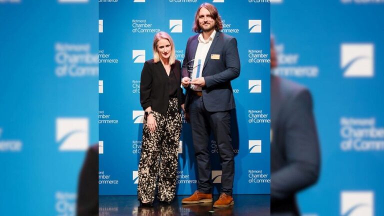 josh mclean right accepts the green business of the year award presented by theresa rawle from vancouver fraser port authority left blurred