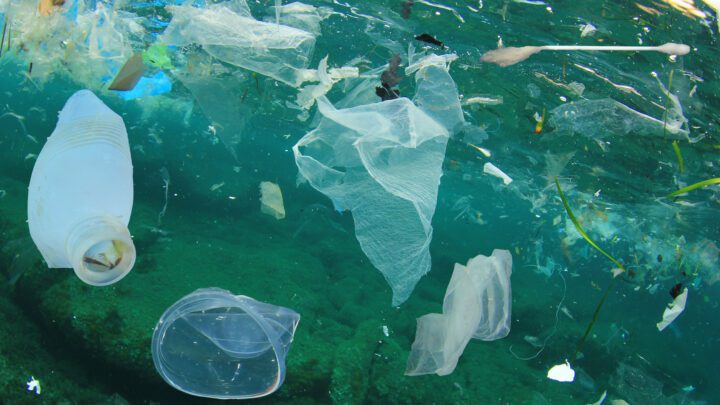 Plastic ocean pollution. Underwater bags, bottles, cups, straws and ear buds